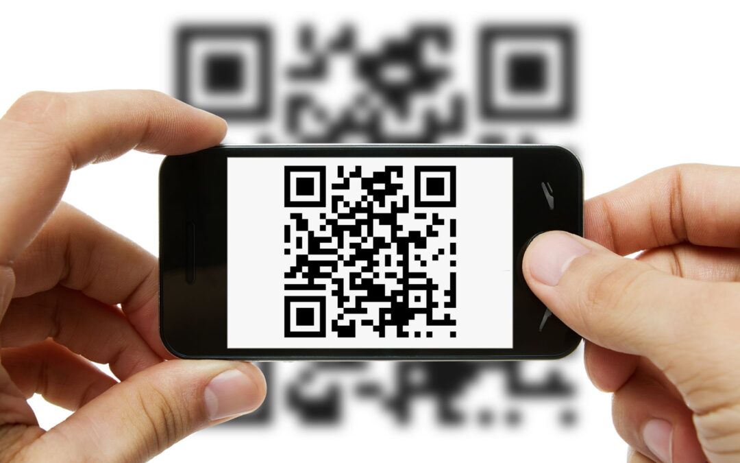 A person holding a phone using a QR code to generate leads.