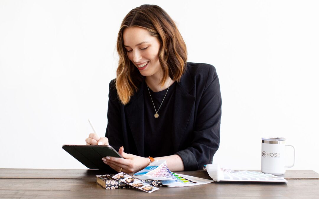 The brand manager of a childcare business smiles as she works through a rebranding checklist on her tablet.