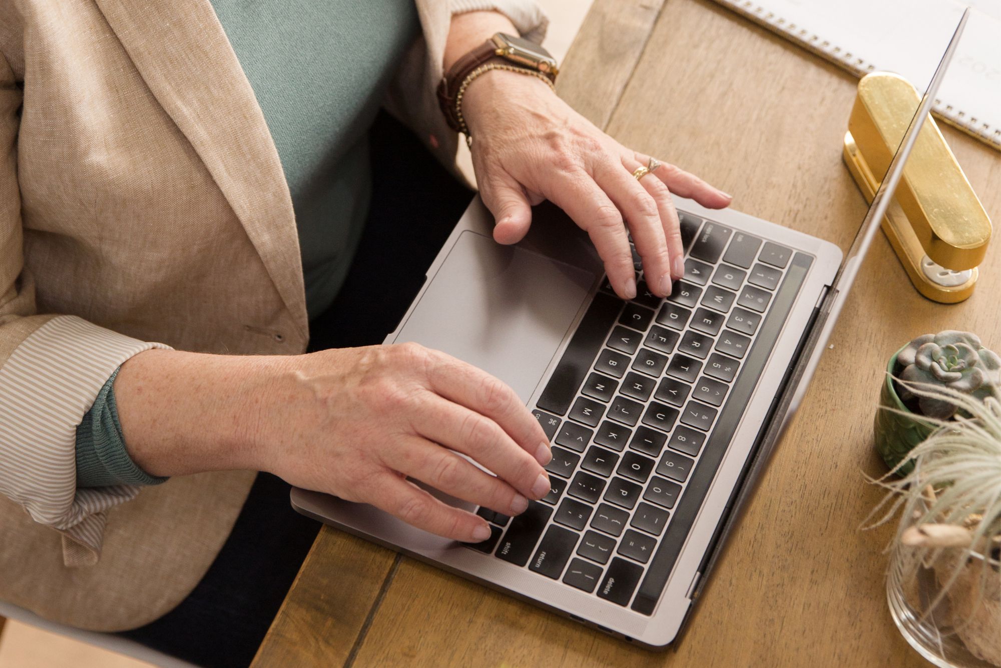 Ruth Ann types on her laptop, looking at a childcare CRM for a client.