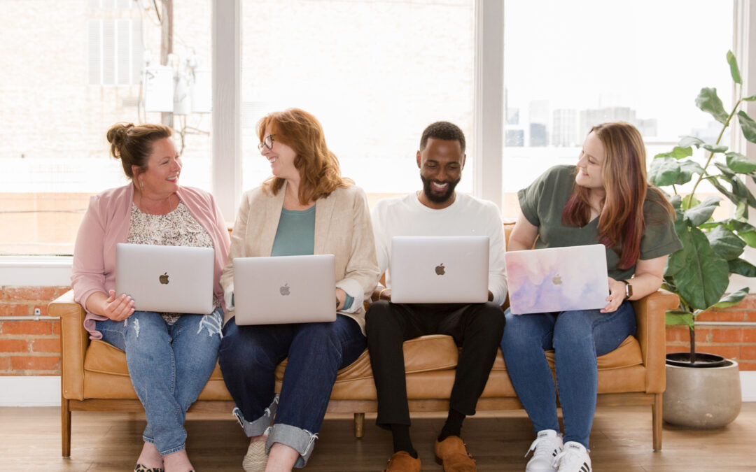 Gwen, Ruth Ann, Rashad, and Madison from Rose Marketing Solutions sitting on a couch with their laptops